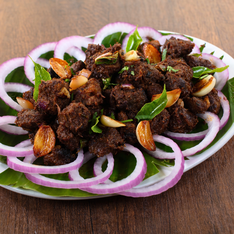 Authentic South Indian Mutton Sukka cooked with traditional Chettinad spices at Karaikudi Restaurant in Scarborough