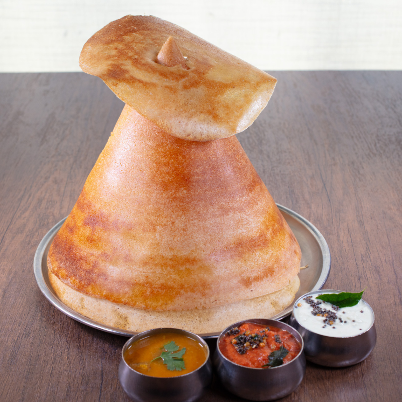 Crispy golden South Indian Ghee Dosa roast served with traditional sambar and varieties of chutney at Karaikudi Chettinad Restaurant