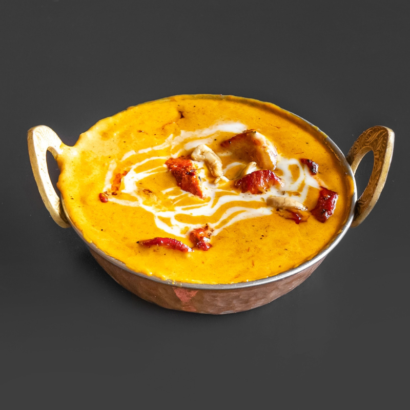 Rich and creamy traditional North Indian Butter Chicken served with fresh naan at Karaikudi Restaurant in Scarborough