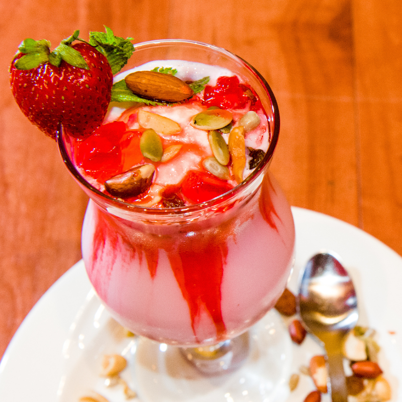 Layered rose syrup Falooda dessert with ice cream, vermicelli noodles, and basil seeds at Karaikudi Chettinad Restaurant