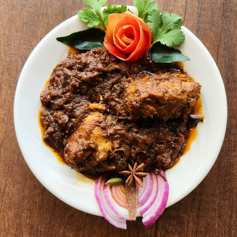 Karaikudi signature Vengaya Chicken—a traditional South Indian onion chicken specialty slow-cooked with fresh small shallots and Chettinad spices