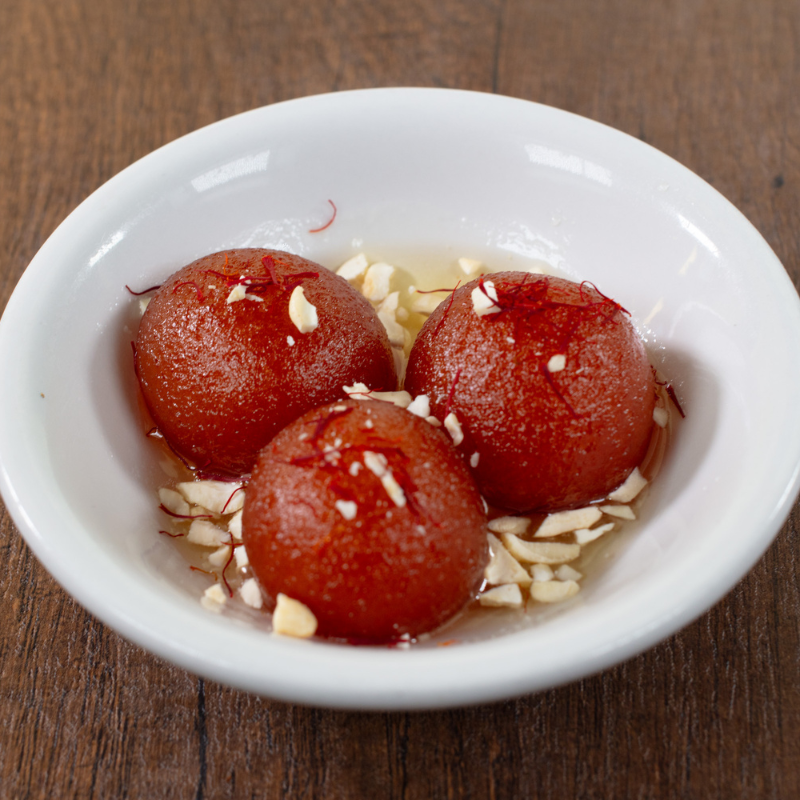 Warm traditional Indian Gulab Jamun sweet dessert served at Karaikudi Restaurant in Scarborough