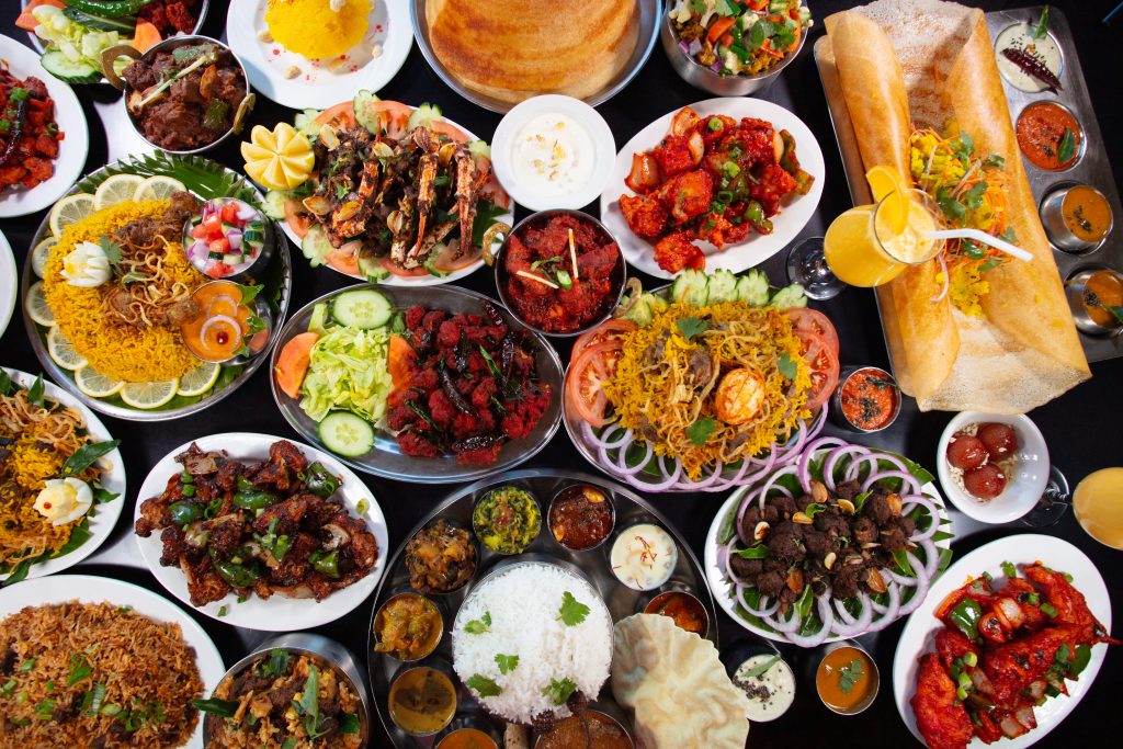 Karaikudi Chettinad Restaurant South Indian food spread with dosa, biryani, curries, and appetizers