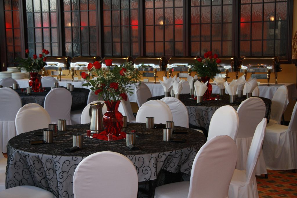 Private banquet hall setup with elegant round tables and formal chair covers for wedding receptions and corporate events at Karaikudi Scarborough