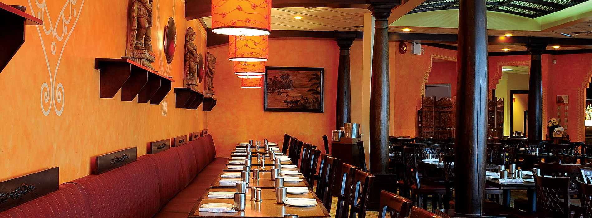 Spacious restaurant dining room at Karaikudi featuring authentic reclaimed heritage rosewood pillars and a bamboo lattice skylight in Scarborough